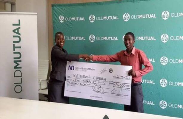 Mrs Edith Jiya presenting a symbolic cheque of K250, 000 to 2015 Old Mutual Mathematics Olympiad best student Mathews Chaula