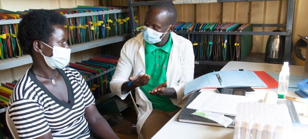 A nurse meets with a HIV-positive patient at a health centre in Namayingo, Uganda.